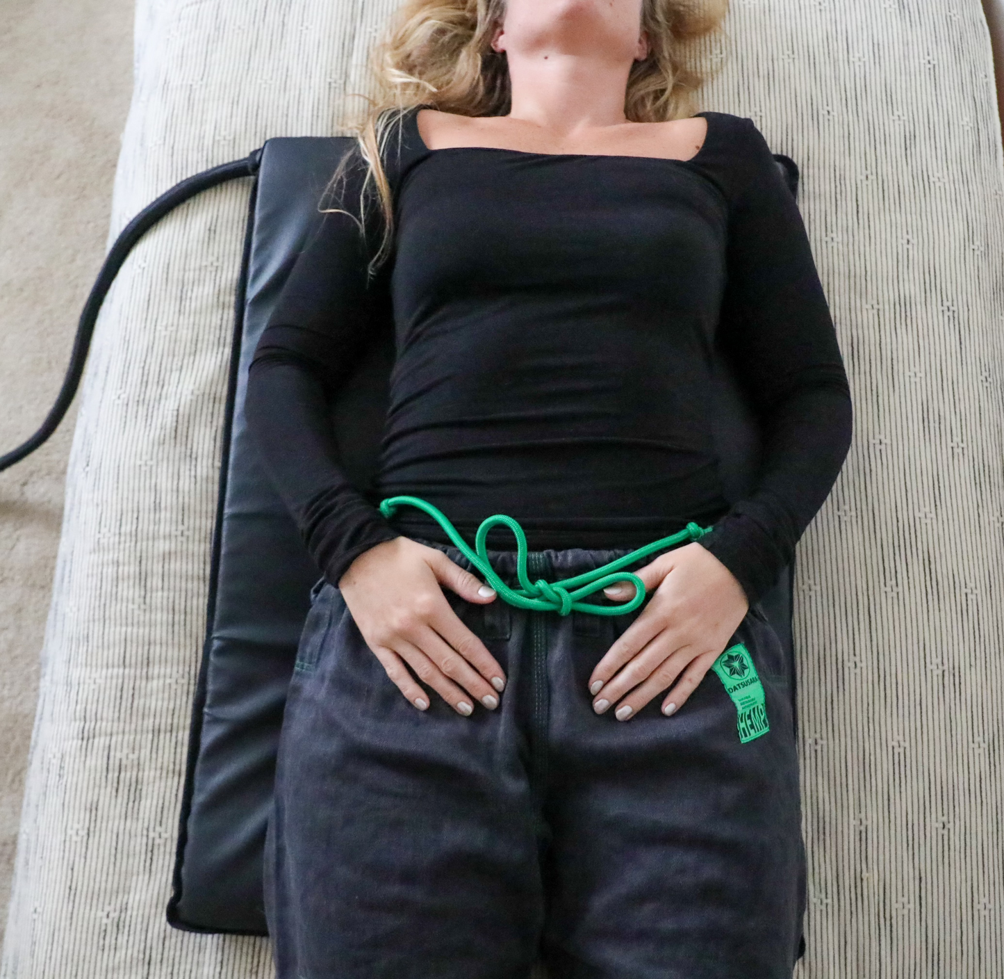 Person laying on ARC PEMF Half Body Mat.