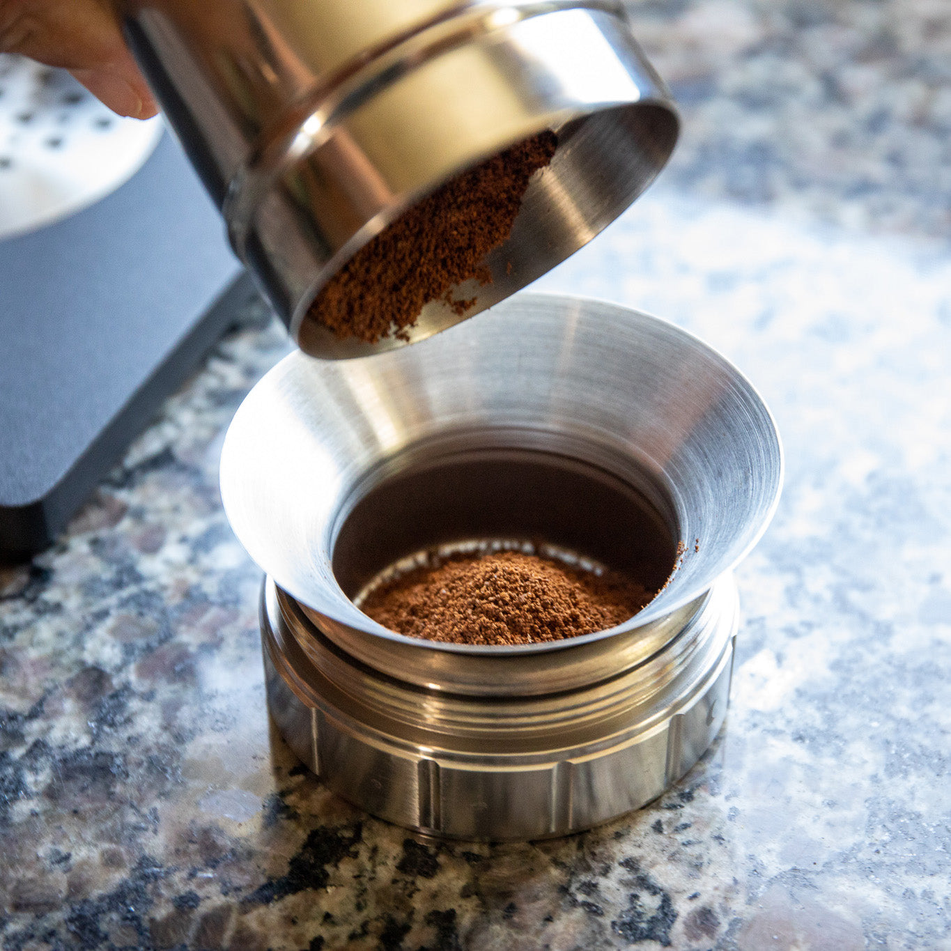 Pictured is someone grinding their Shen Blossom Japanese Coffee Beans.