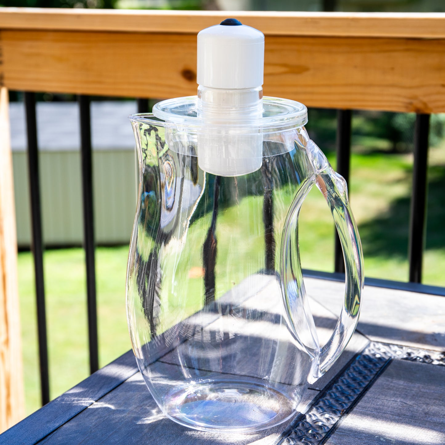 A MRET Water Activator sits on a table outside on a sunny day