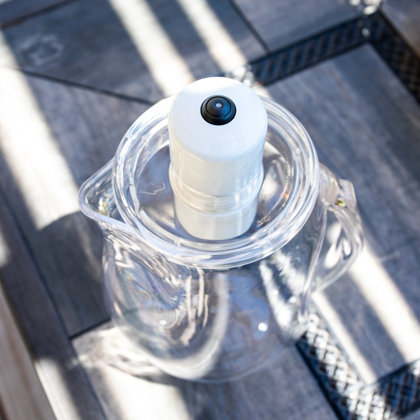 A top view picture of the MRET Water Activator that's sitting on a table outside on a nice day