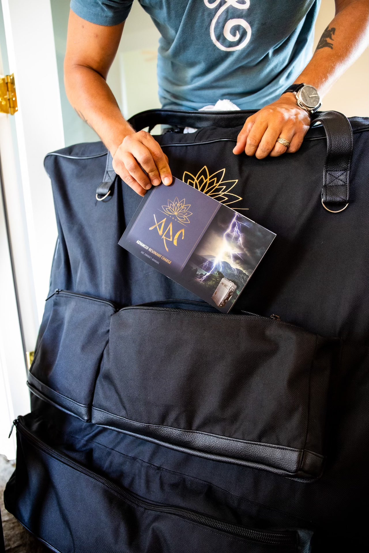 Man putting ARC PEMF owner's manual into the carrying case