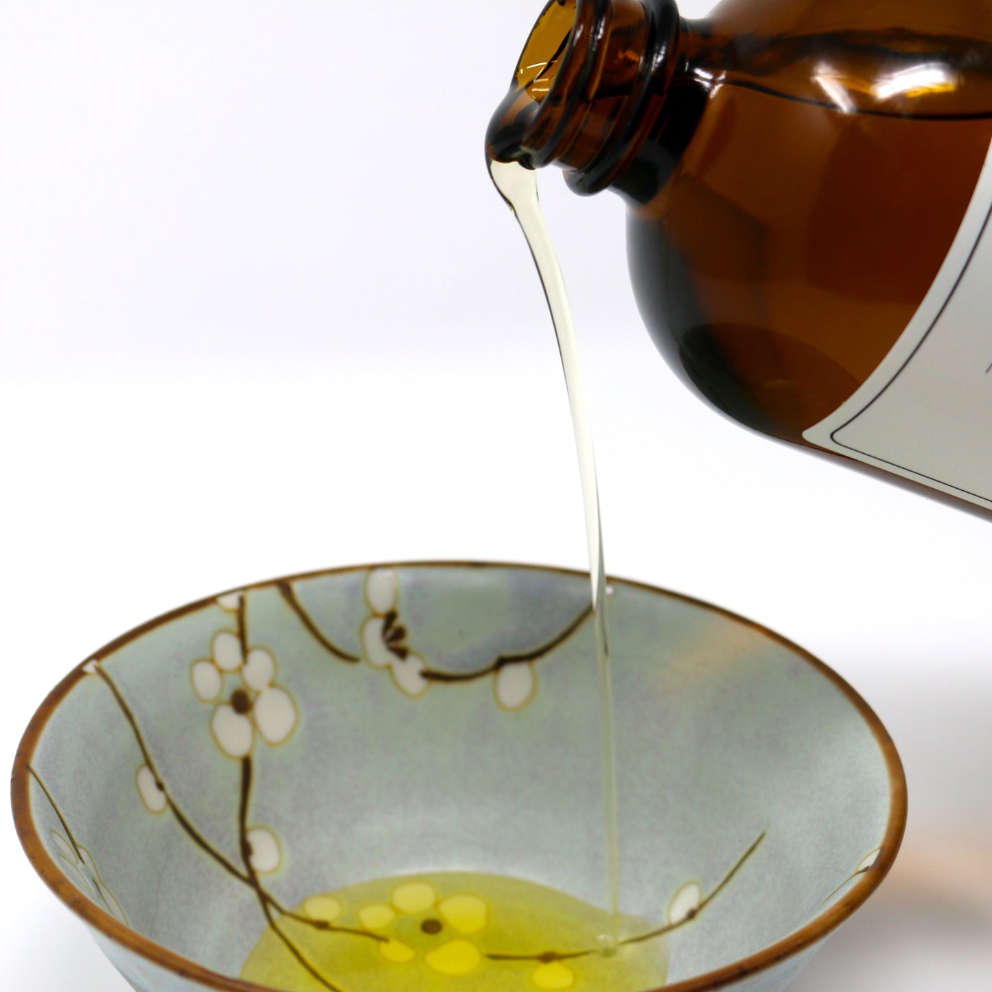 This picture shows Shen Blossom's Gobo Root Oil being poured in bowl