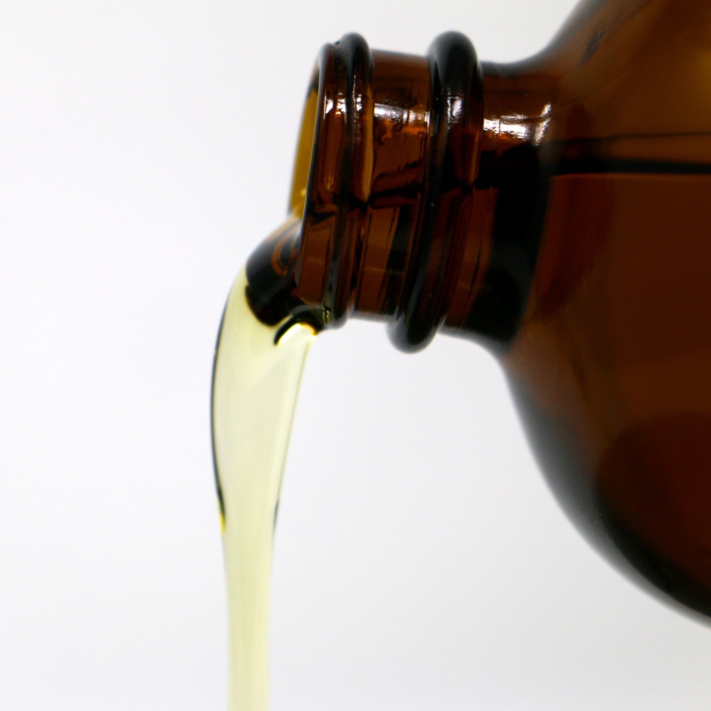 A close up picture of Shen Blossom's Gobo Root Oil being poured from a bottle