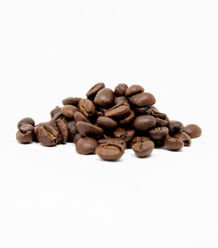 A pile of coffee beans photographed on a white background