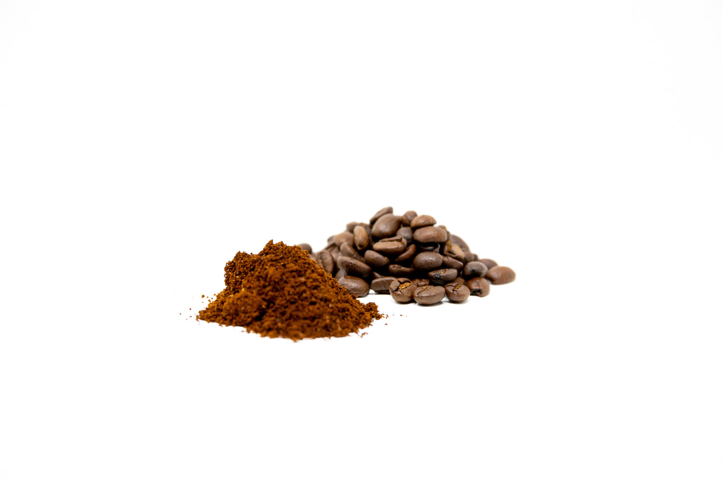 A pile of ground coffee/beans photographed on a white background