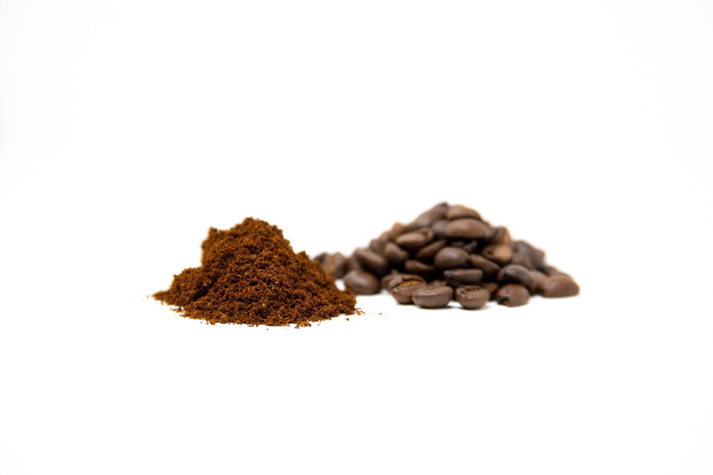 A pile of ground coffee/beans photographed on a white background