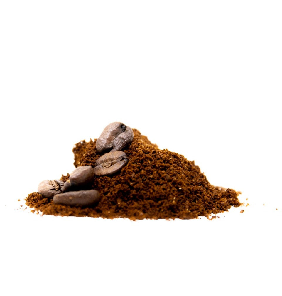 A pile of ground coffee/beans photographed on a white background