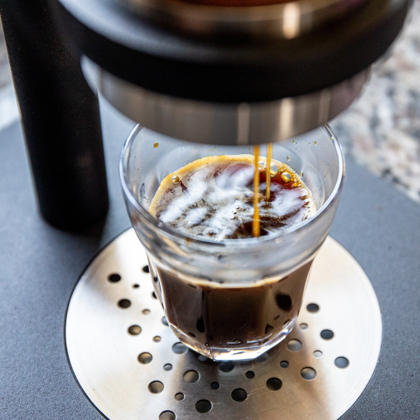 Pictured is someone brewing a cup of coffee using Shen Blossom's Japanese Coffee Beans.
