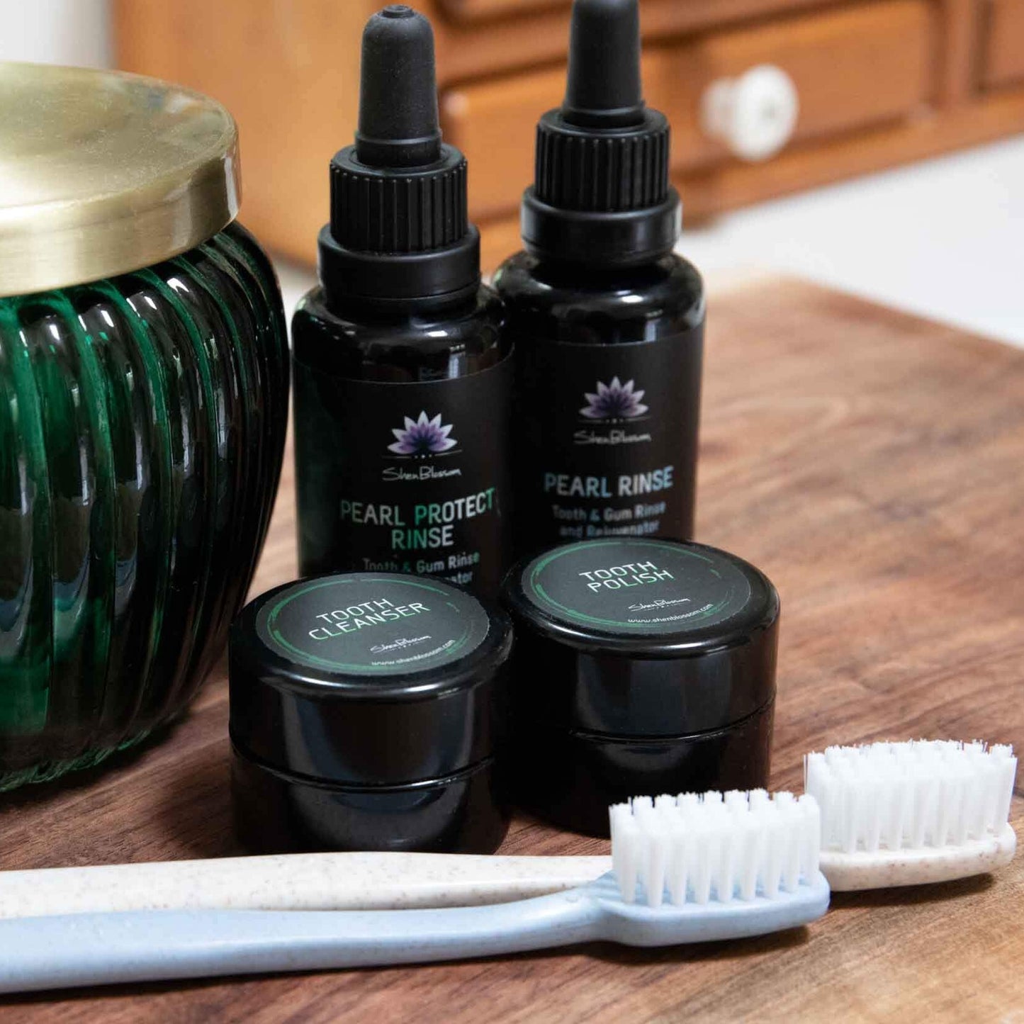 Tooth Spa Bundle photographed on a bathroom counter next to toothbrushes