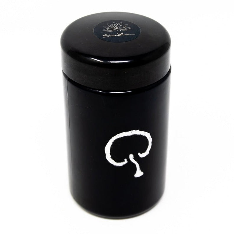 A jar of Shen Blossom's Wild Red Reishi Mushroom Full Spectrum Powder photographed on a white background