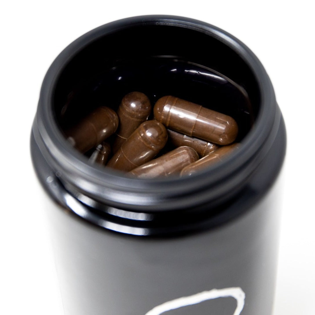 Shen Blossom's Wild Red Reishi Mushroom Full Spectrum Powder photographed showing the capsules inside the jar