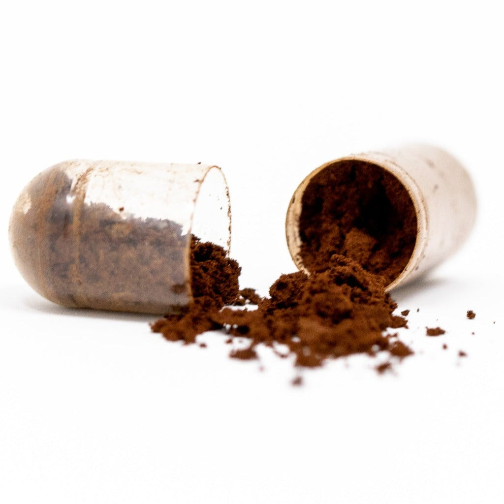 Shen Blossom's Wild Red Reishi Mushroom Full Spectrum Powder capsule split showing the contents inside