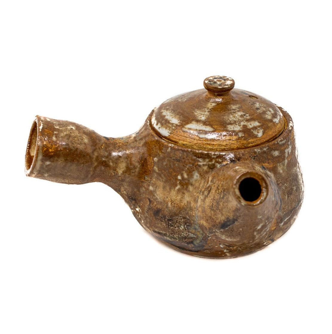 A burnt orange tea pot photographed on a white background