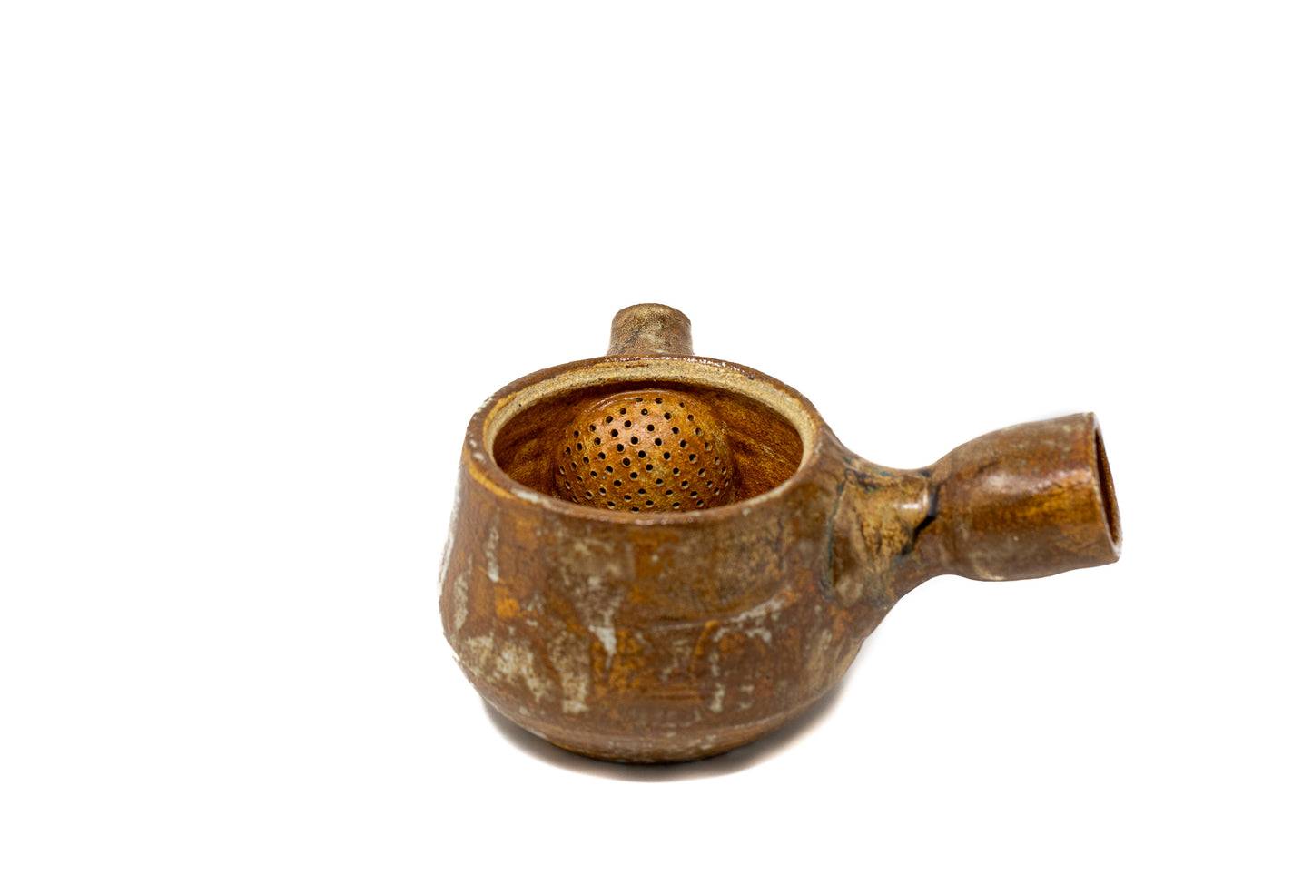 A burnt orange tea pot photographed on a white background