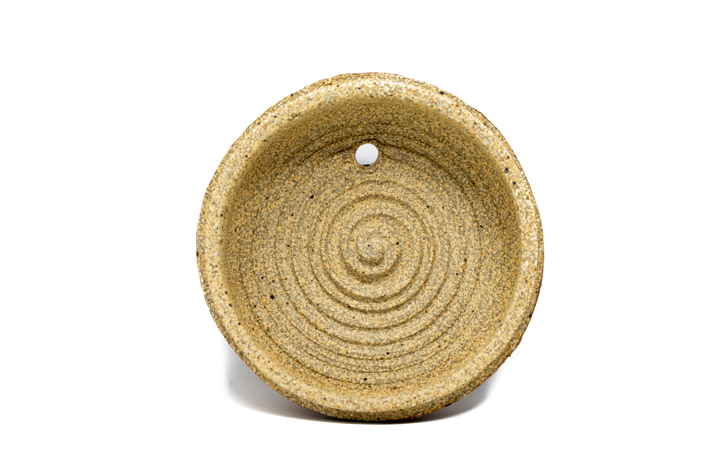 A burnt orange tea pot lid photographed on a white background
