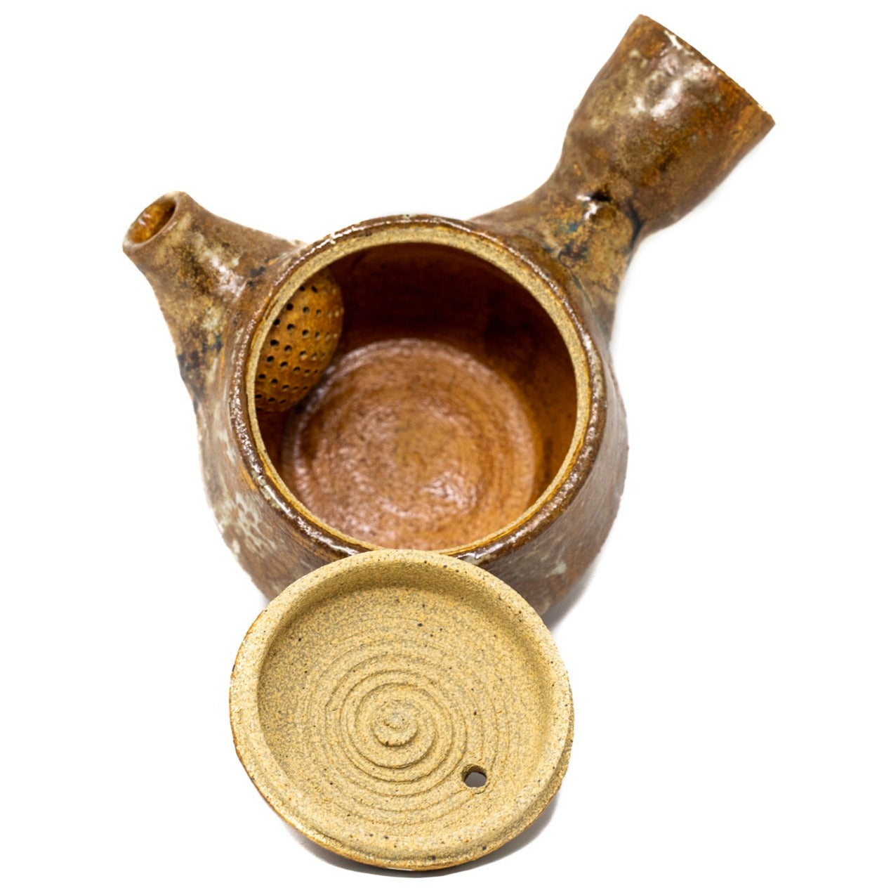 A burnt orange tea pot photographed on a white background