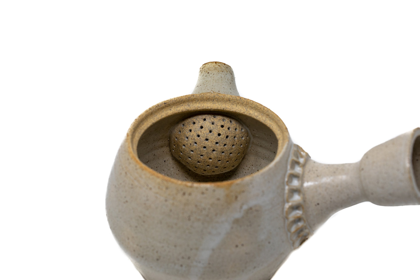 A white tea pot photographed on a white background