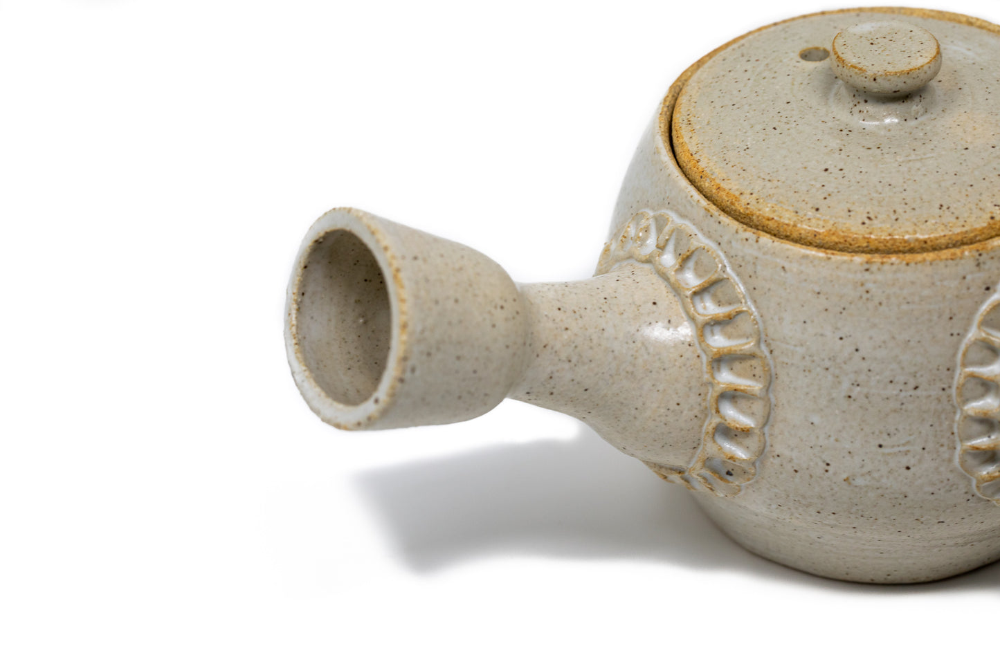 A white tea pot photographed on a white background