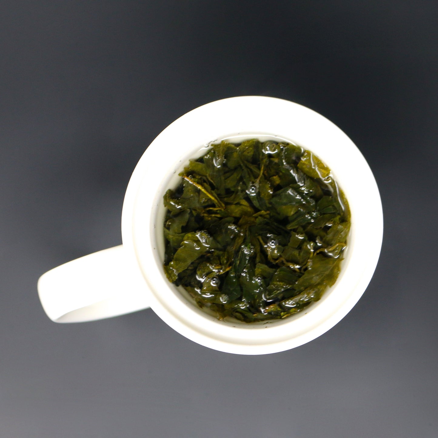 Pictured from above is Shen Blossom's Amacha Loose Leaf Tea infusing in a tea cup