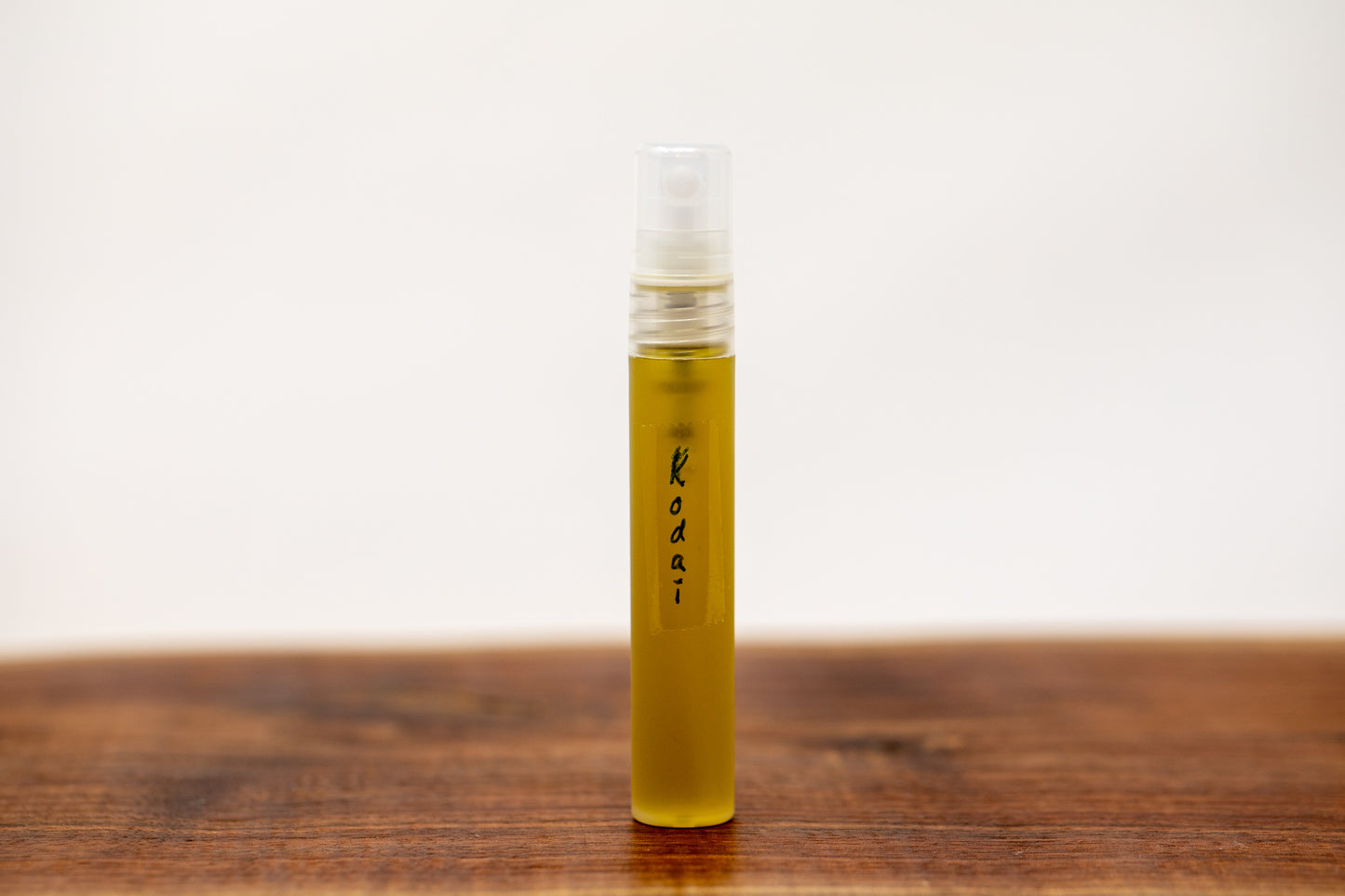 Shen Blossom's Kodai Branch Face Serum is displayed on a wooden tray
